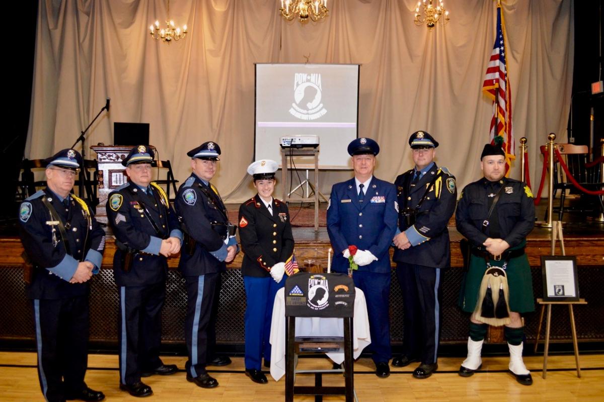 POW/MIA Chair of Honor Ceremony at Ipswich Town Hall - Ipswich Police Honor Guard and Bagpiper pose for photo in front of the st